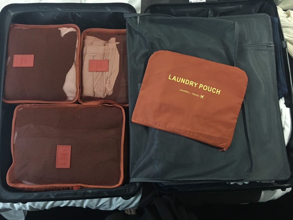 A suitcase with neatly organised packing cubes. 
